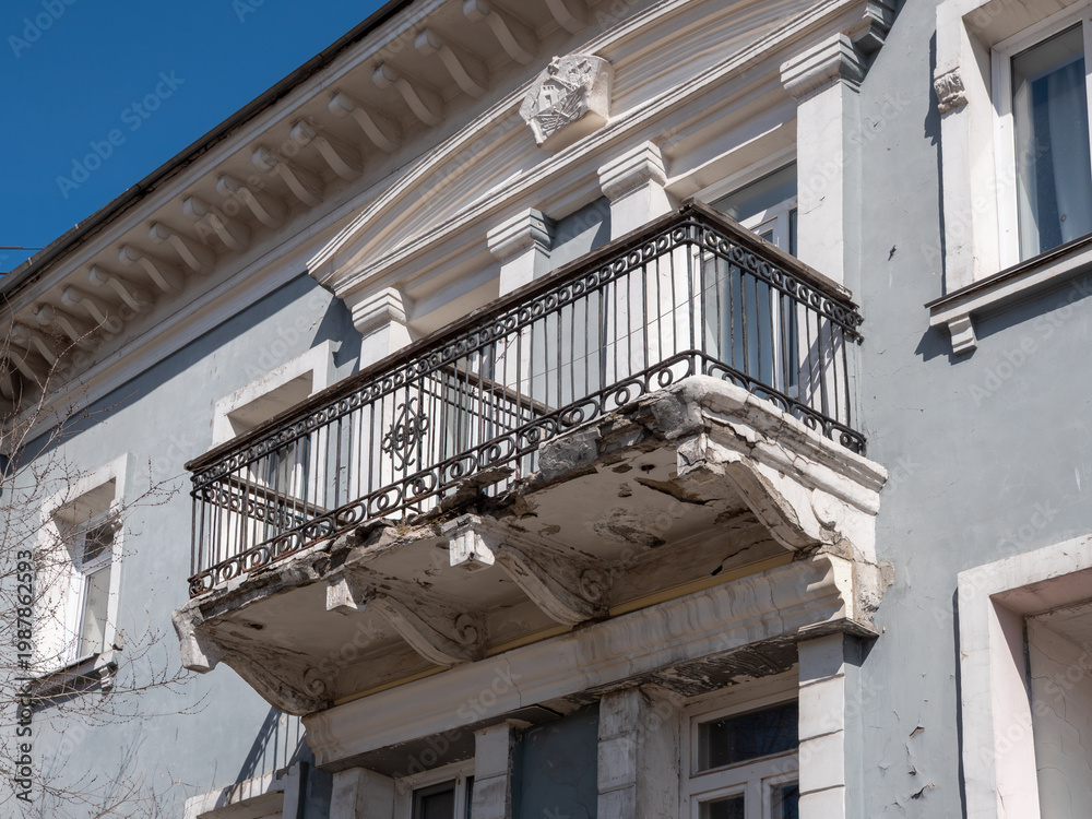 Fototapeta premium Old vintage balcony in need of restoration weathered architectural detail on building facade.