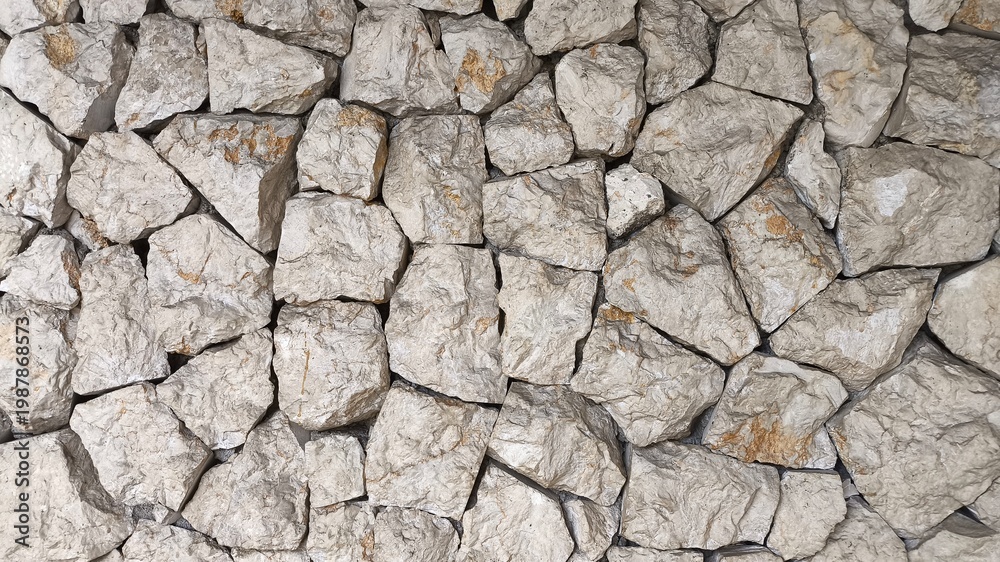 Fototapeta premium Close up grey old weathered stone wall texture with rough surface and natural erosion pattern, abstract grunge background perfect for rustic design, construction theme and vintage backdrop