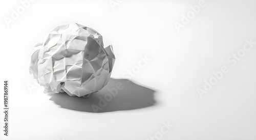 Monochrome still life a crumpled paper ball on a white surface