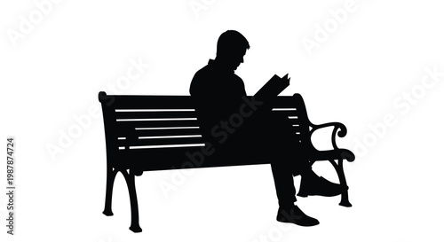 A man reads a book while seated on a park bench silhouette