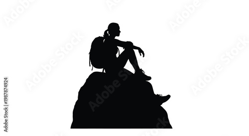 A lone hiker rests on a rock a striking black silhouette