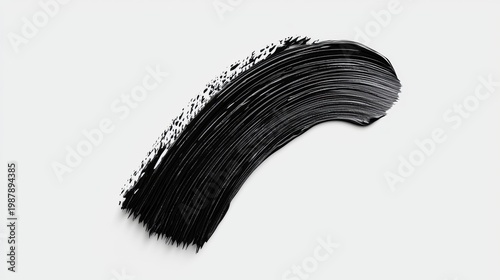 A black mascara swatch with white speckles.