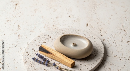 Serene Ambiance: A minimalist composition featuring a lit candle, aromatic Palo Santo wood, and sprigs of lavender creates a tranquil and inviting atmosphere.