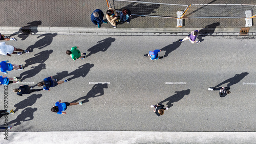 Canvastavla Aerial drone view of people running half marathon race in city, shadows of runne