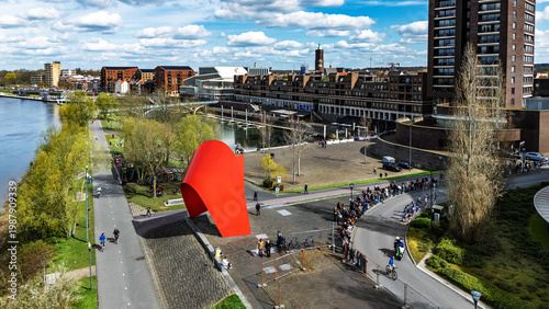 Aerial drone view of people running half marathon Venloop race in city, crowd runners on road racing sport competition, top-down view of athletes and spectators, Venlo, the Netherlands