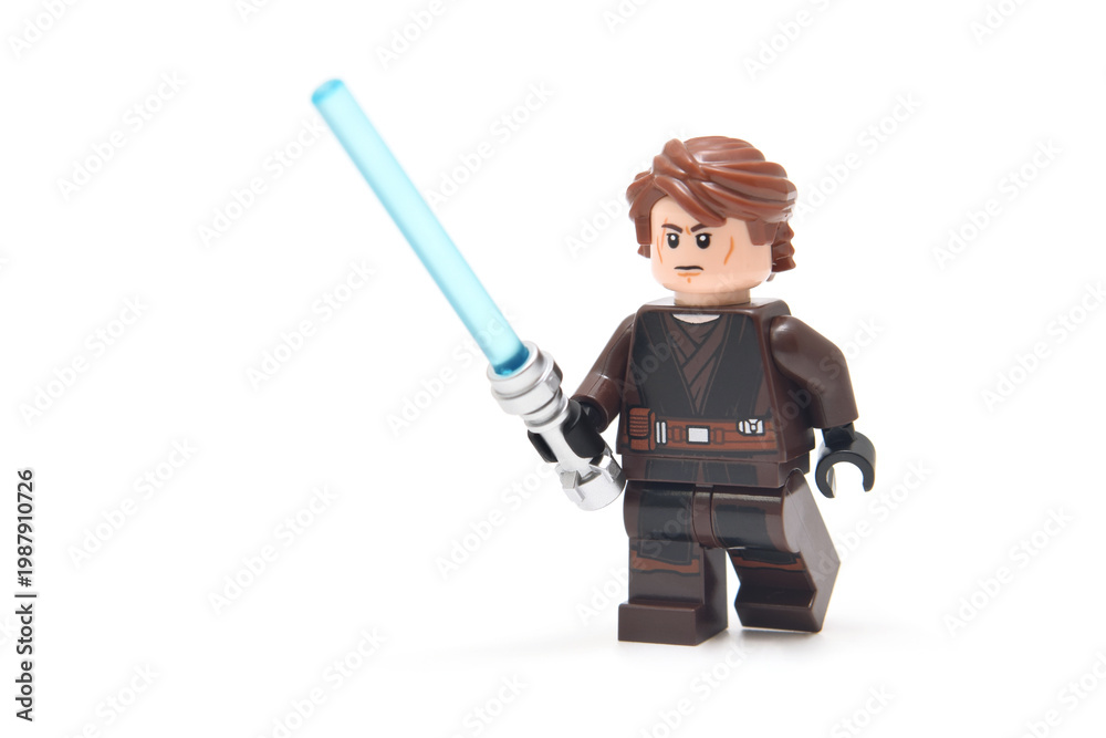 Obraz premium Lego minifigure of Anakin from Star Wars with blue lightning sword isolated on white. Editorial illustrative image of popular plastic constructor.