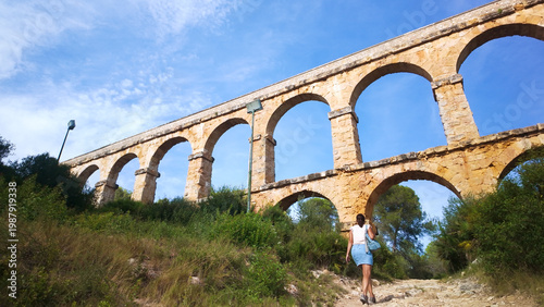 Obraz na płótnie Woman hiking ancient Roman aqueduct in Tarragona Spain