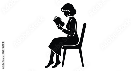 Woman reading a book while seated in a chair silhouette