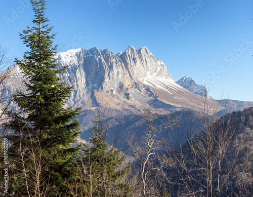 Autumn, a fragment of a mountain range in the light of the daytime sun, dried vegetation and nature walks