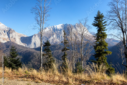Autumn, a fragment of a mountain range in the light of the daytime sun, dried vegetation and nature walks