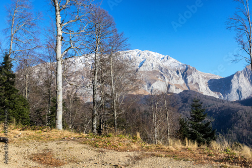 Autumn, a fragment of a mountain range in the light of the daytime sun, dried vegetation and nature walks