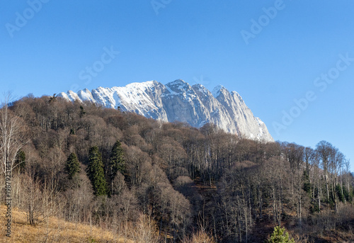 Autumn, a fragment of a mountain range in the light of the daytime sun, dried vegetation and nature walks