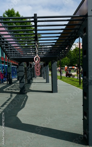 A girl is completing a suspended obstacle course at a street workout area. OCR (Obstacle Course Racing)
