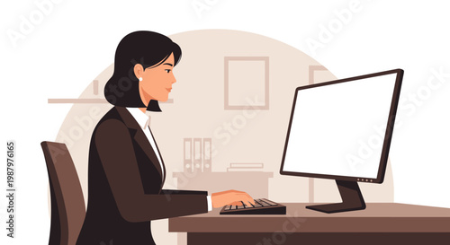 woman sitting at desk working on computer.
