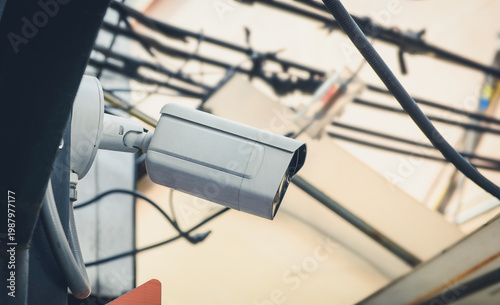 A modern white CCTV security camera mounted outdoors on a building, representing surveillance, protection, and modern technology.