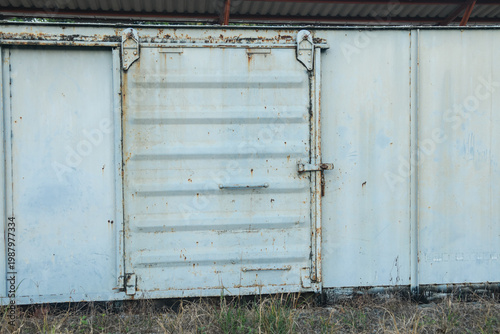 Old weathered train bogy cargo container with rust and scratches, showing aged metal textures and industrial details, perfect for concepts of history, transportation, and decay.