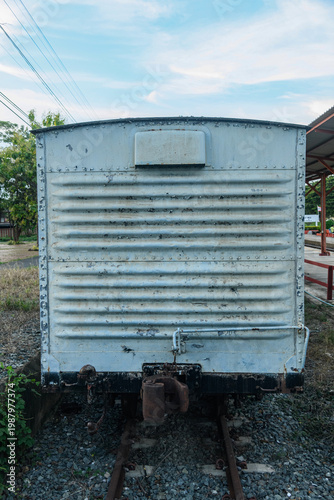 Old weathered train bogy cargo container with rust and scratches, showing aged metal textures and industrial details, perfect for concepts of history, transportation, and decay.