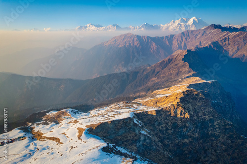 Canvas Print A breathtaking aerial view of snow-capped mountains and rugged landscape near Tu