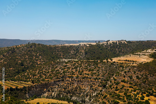 Picturesque mountain landscape with Mediterranean vegetation and terraces under a clear blue sky