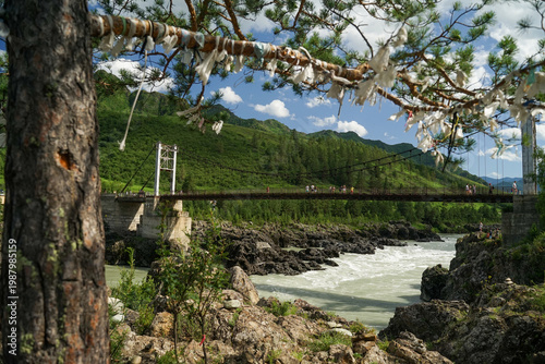 a bridge over a river in the mountains
