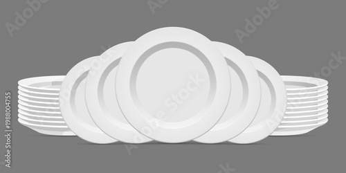 Stack of white plates arranged on a gray surface, simple dinnerware set.