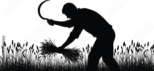 A silhouette of a person harvesting crops with a sickle in a field