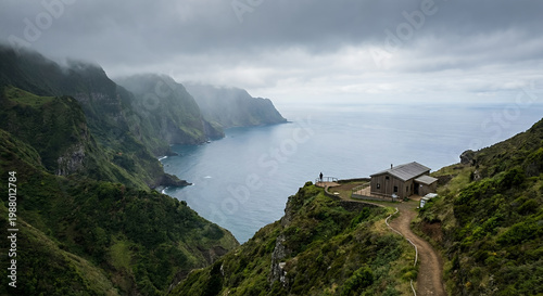 A lone figure stands on a cliff edge overlooking the ocean, next to a wooden cabin.
