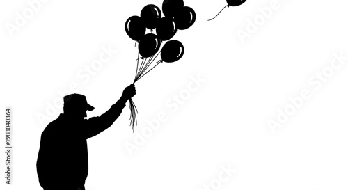 Silhouette of a person in a cap holding a bunch of black balloons floating away against a white background