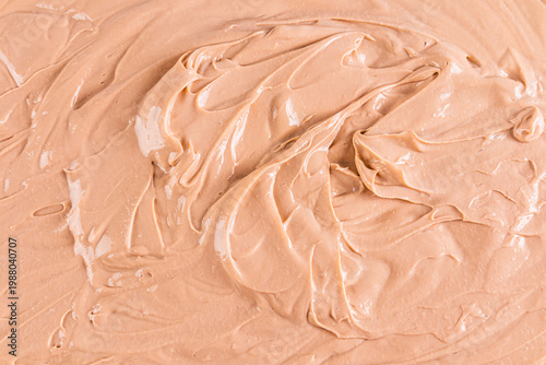 The delicate texture of beige buttercream with condensed milk. Chic texture pattern product. Layout for culinary design. . Top view. selective focus