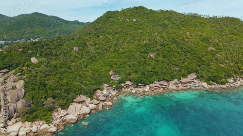 Rocky Coastal Village With Clear Waters. Picturesque Thai Coast With Bungalows And Coral Reefs