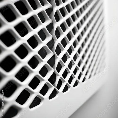 Close up of textured white grate with intricate geometric patterns