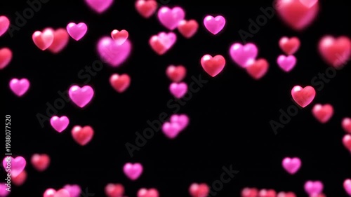 Pink and red heart bokeh lights on black background