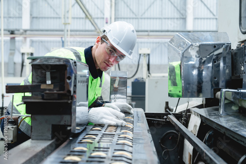 Фотография Technician meticulously inspects complex metal rack with white gloves in dimly lit industrial environment, emphasizing quality control and focused attention during machinery maintenance