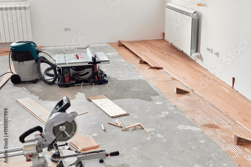 Assembling new laminate hardwood floor.