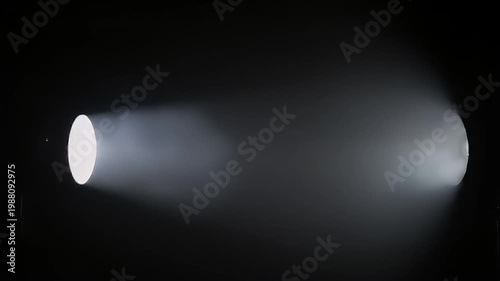Bright white light beam illuminating dark smoky background