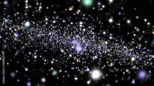 Glittering golden and blue lights sparkling on black abstract background