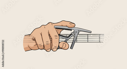 Hand holding a guitar capo on strings