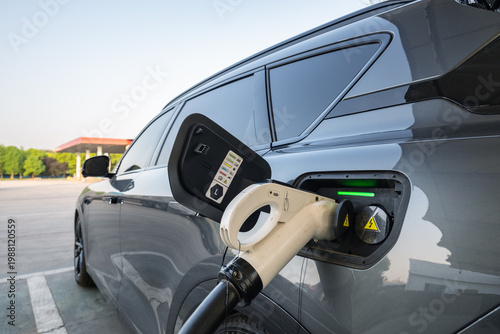 Electric Car Charging at Public Station with Green Status Light