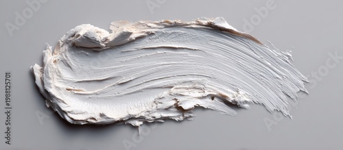 Creamy White Moisturizer Spread on Light Gray Surface in Artistic Style