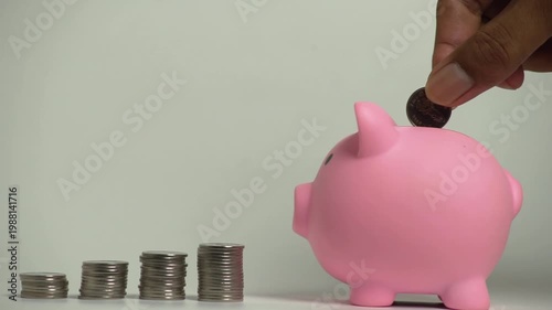 Save money and account banking for finance concept, Hand with coin and piggy bank on blurred background