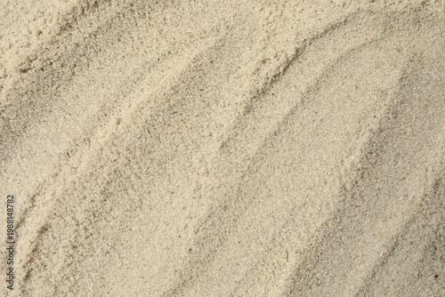 Sand on the beach as background, top view