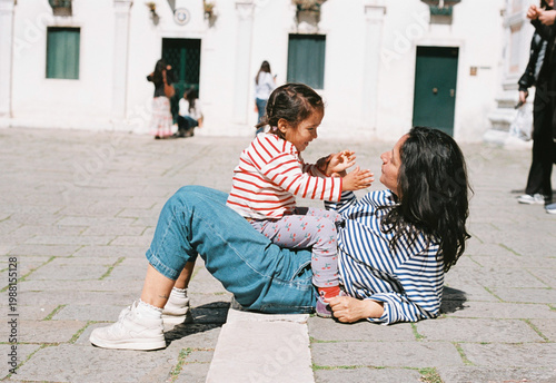 analog film photo of mother and daughter travelling together during summer holidays in Venice, smiling and bonding, concept of motherhood