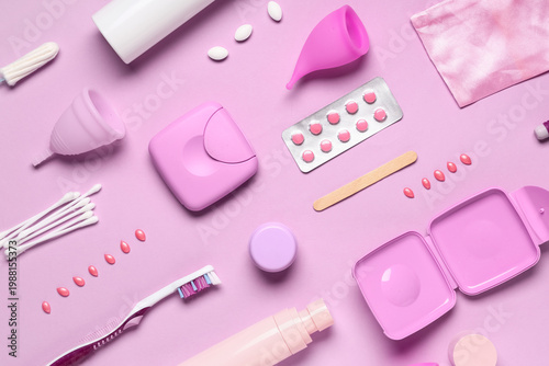 Different feminine hygiene items on pink background