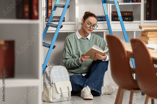 Young woman reading book un...