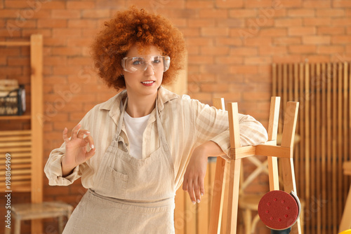 Young female carpenter with...