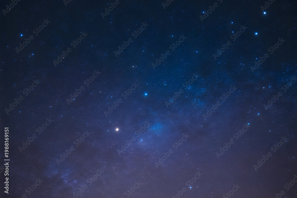 Fototapeta premium Deep indigo night sky filled with scattered bright stars and cosmic dust clouds
