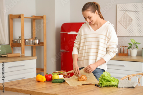Young happy woman wrapping ...