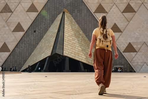 Canvas Print A Caucasian woman walks toward the main entrance of the Giza Museum