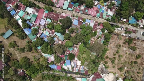 Aerial view of a densely populated residential area, showcasing informal settlements along the railroad in a poorly managed developing city.