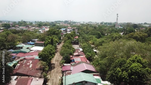 Aerial view of a densely populated residential area, showcasing informal settlements along the railroad in a poorly managed developing city.